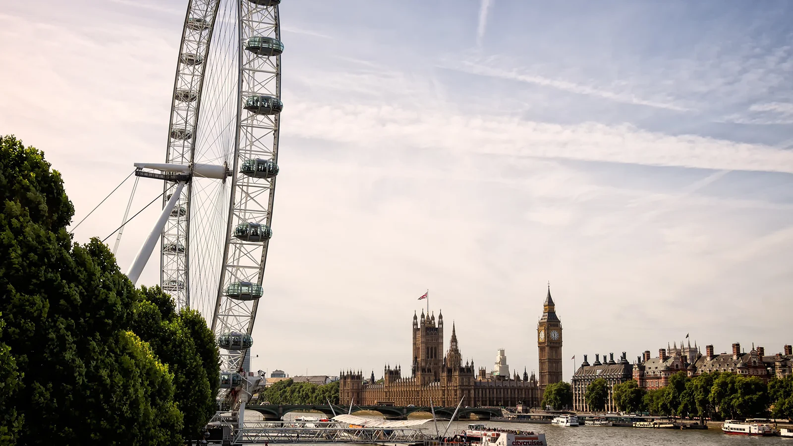 London Eye observation wheel and Palace of Westminster with Big Ben beside River Thames