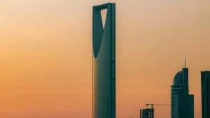 Riyadh skyline featuring Kingdom Centre Tower and modern high-rises in golden light
