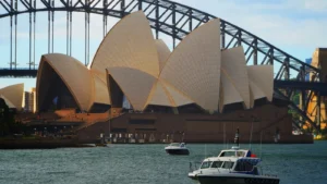 Sydney Opera House sails and Sydney Harbour Bridge above waterfront in daylight