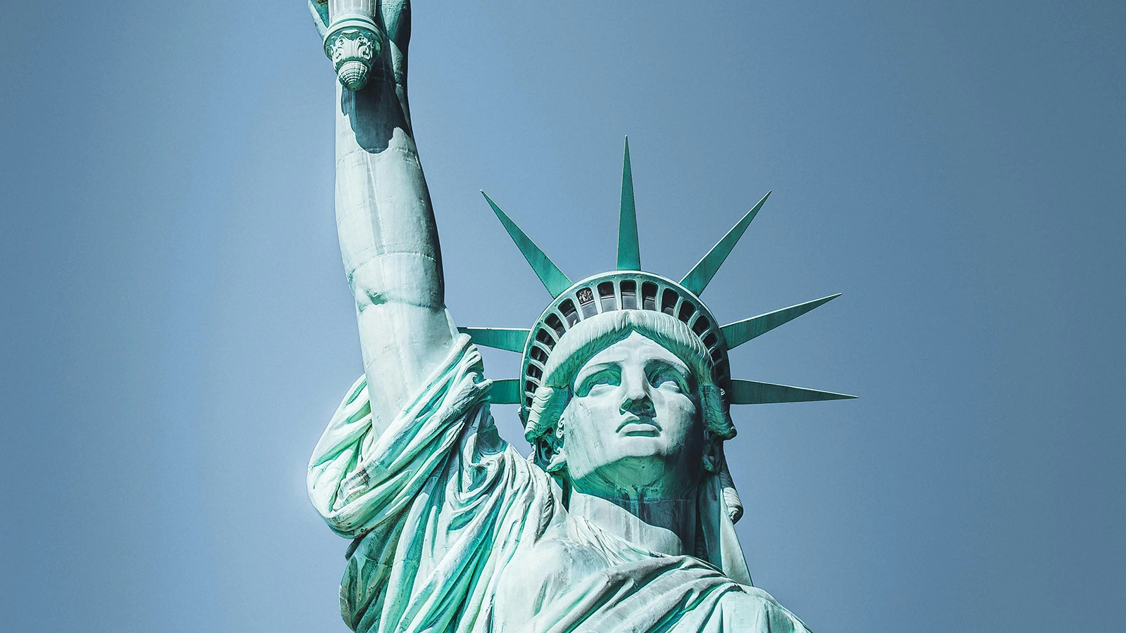 Close-up of the Statue of Liberty holding torch against clear blue sky