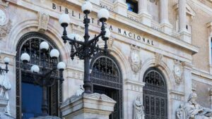 Biblioteca Nacional building facade with ornate arches, statues, and decorative street lamps