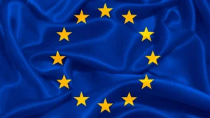 European Union flag with twelve yellow stars on a rippling blue background