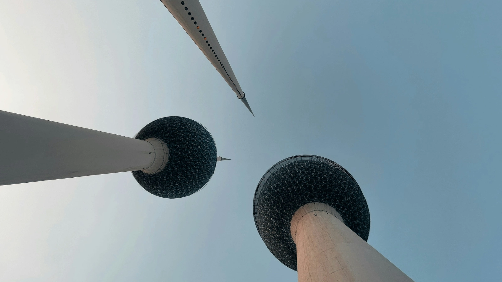 Iconic Kuwait Towers from ground perspective, textured spheres and slender spire above
