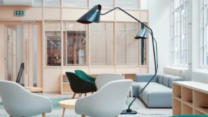 Contemporary seating area for digital nomads featuring sofas, chairs, large windows, minimalist shelving