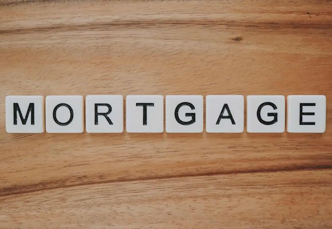 Wooden tiles spelling out the word mortgage on a wood surface