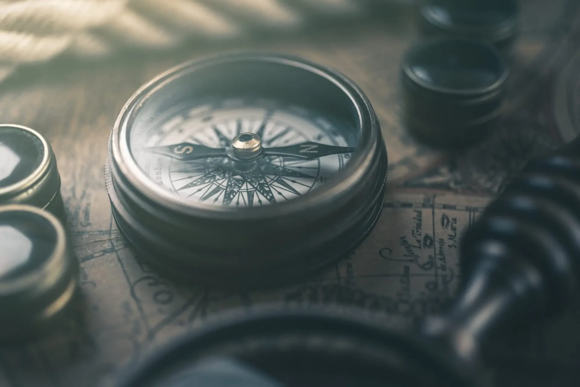 Close-up of a brass compass resting on a dark surface