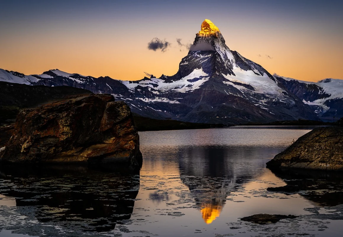 The Matterhorn reflected in a still alpine lake at dusk near Zermatt, Switzerland