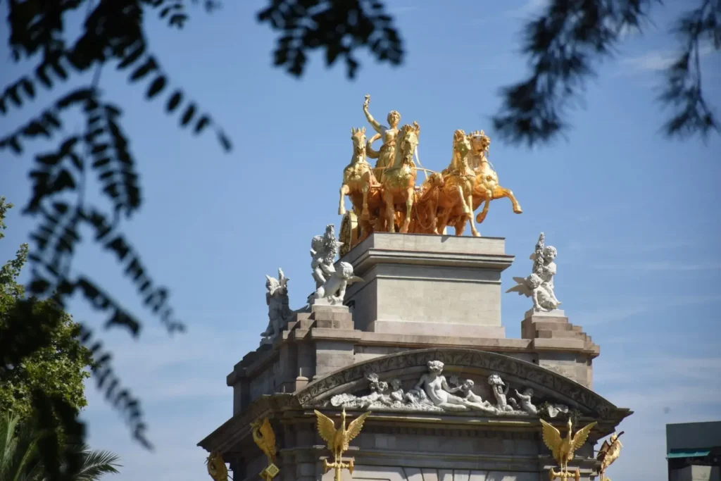 Golden equestrian statue against a blue sky