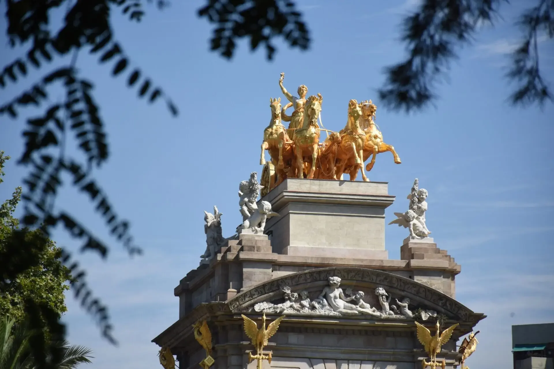 Golden equestrian statue against a blue sky