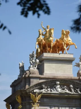 Golden equestrian statue against a blue sky