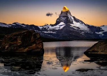 The Matterhorn reflected in a still alpine lake at dusk near Zermatt, Switzerland